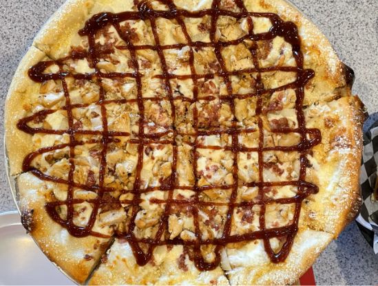 Yummy BBQ Chicken Pizza with sauce drizzled in a criss-cross pattern on top